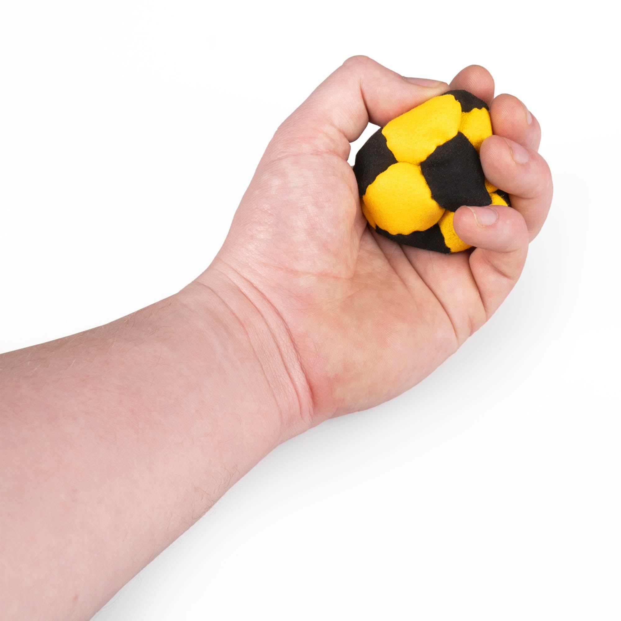 Yellow and black hacky sack in hand