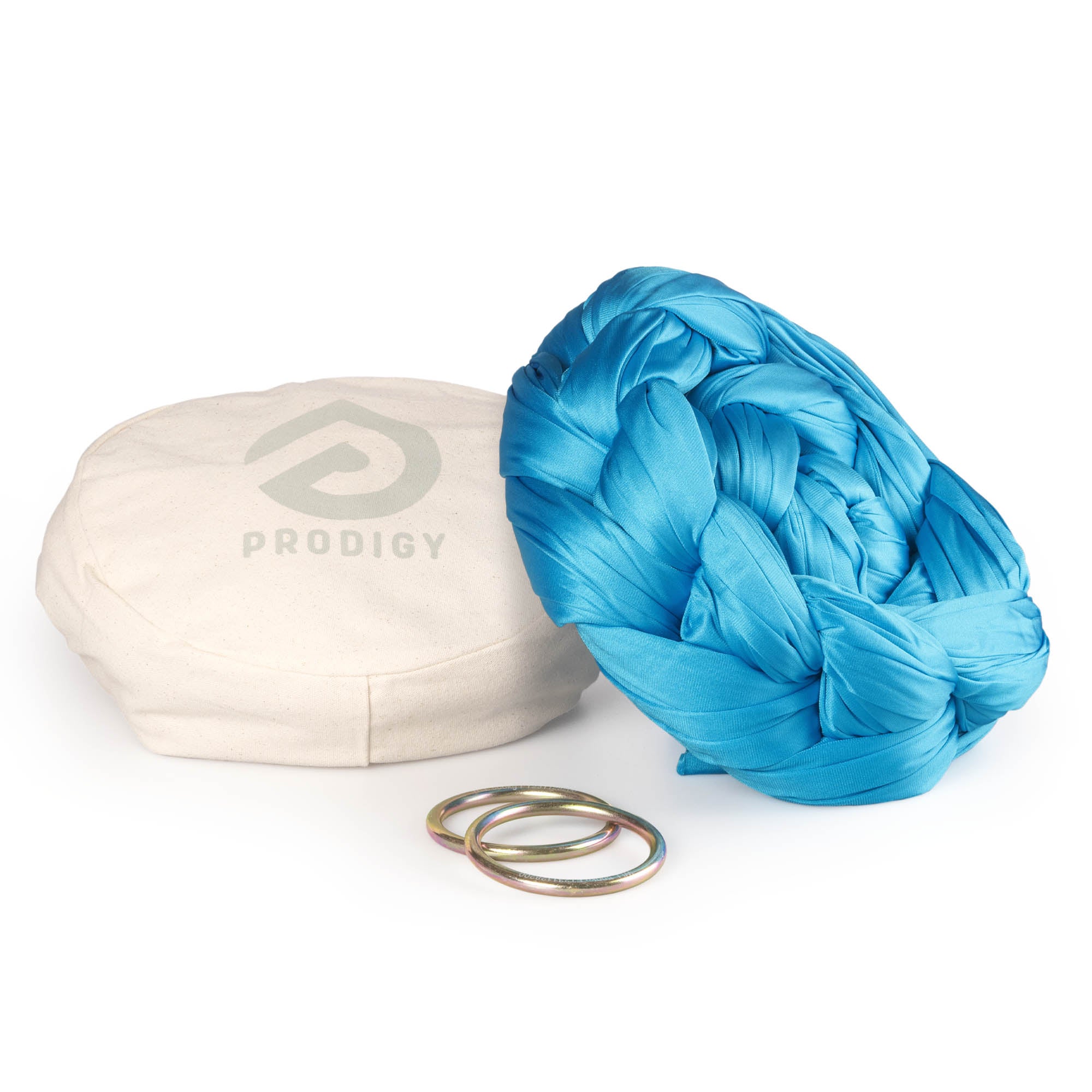 Turquoise yoga hammock resting on eco bag with O-rings laying in front