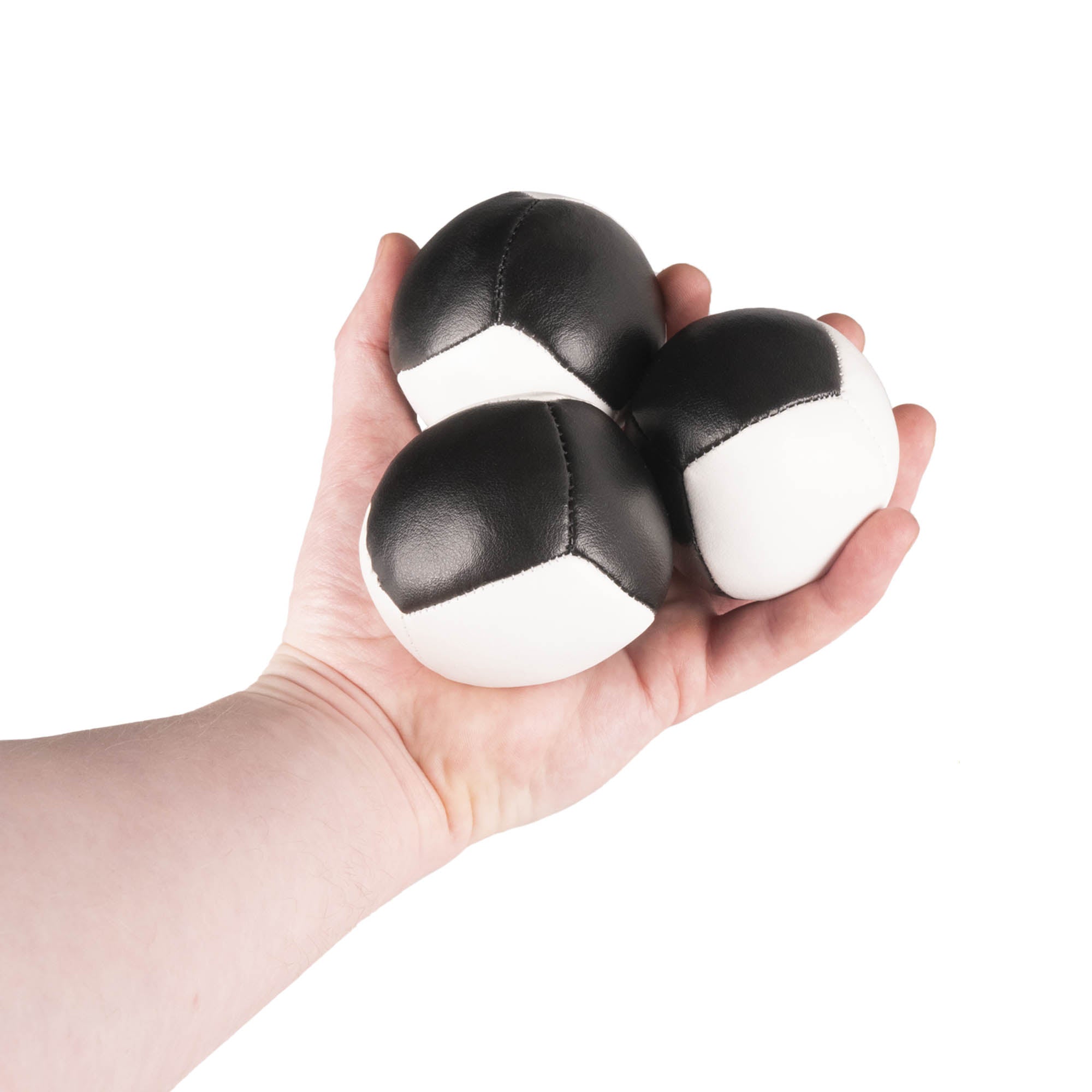 Firetoys three black/white 110g thud juggling balls in hand