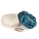 Pine green yoga hammock resting on eco bag with O-rings laying in front