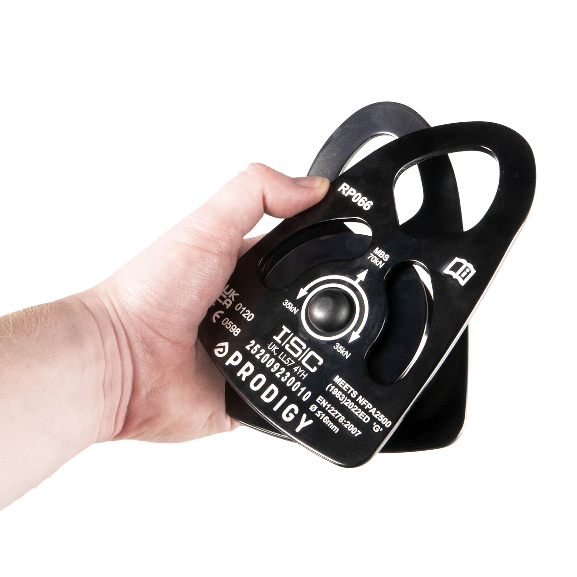 Hand holding a black ISC Prodigy pulley on a white background