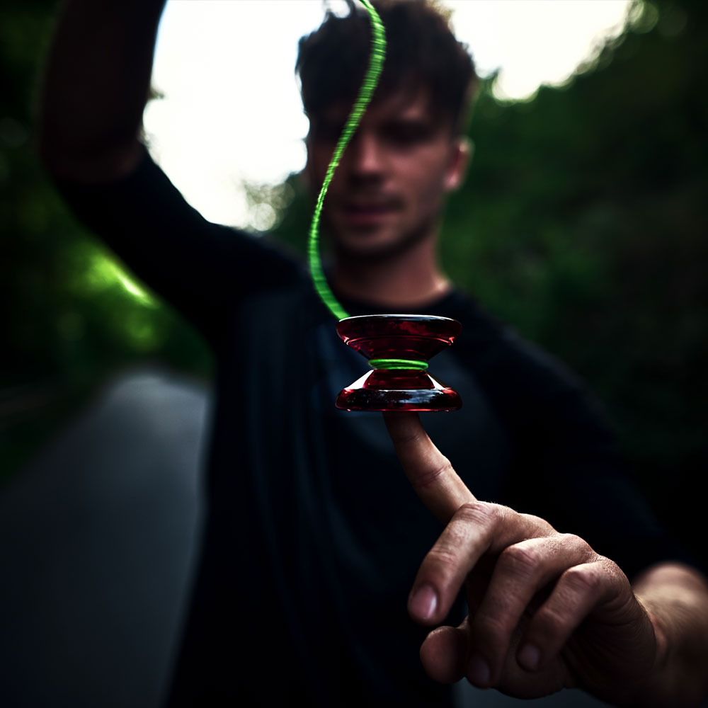 red yoyo spinning on finger
