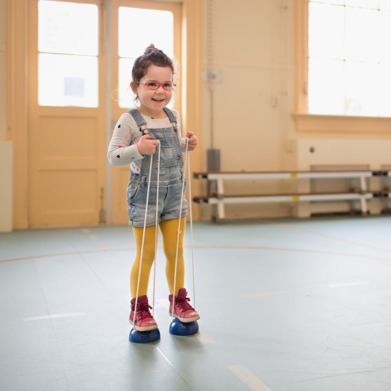 A child using wooden walking bobbins